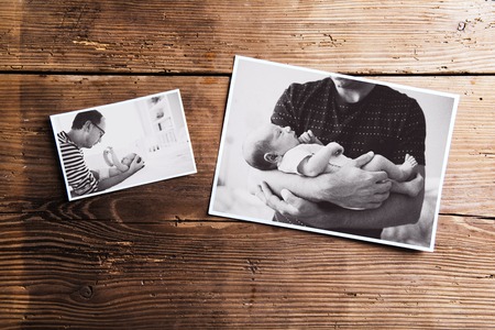 Pictures of father and baby, wooden background. Fathers day.の写真素材