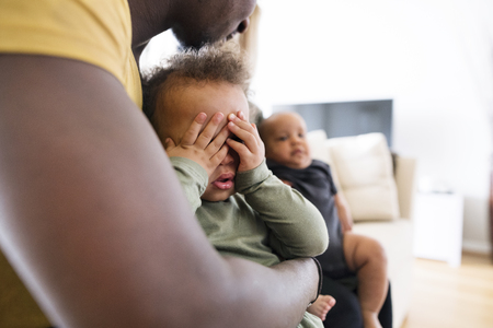 Unrecognizable afro-american father holding his little daughterの写真素材