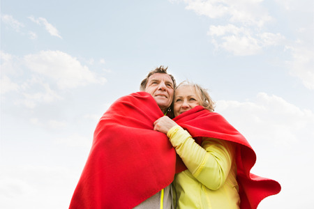Beautiful senior runners resting outside in sunny autumn natureの写真素材