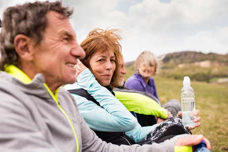 Group of senior runners outdoors, resting and talking.の写真素材