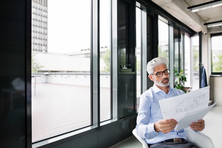 Mature businessman in blue shirt in the office.の写真素材
