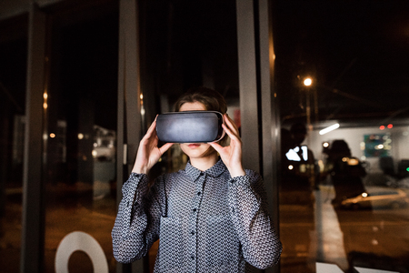 Businesswoman in the office wearing virtual reality goggles.の写真素材