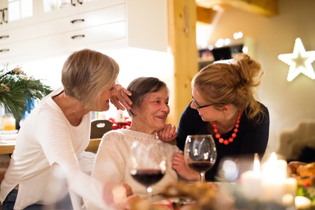 Mother, grandmother and daughter celebrating Christmas.の写真素材