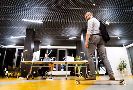 Businesspeople in the office at night working late.の写真素材