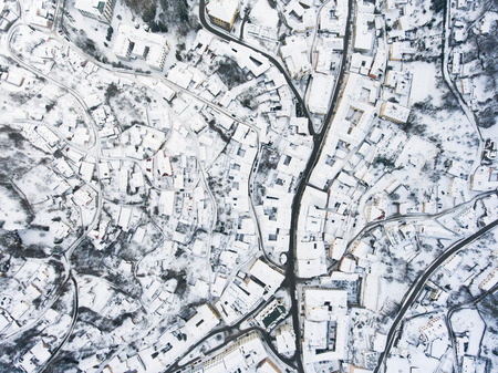 Aerial view of small town with hills in winter.の写真素材