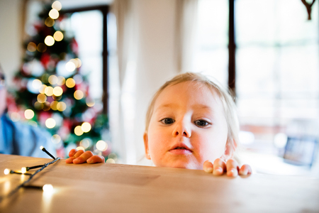 Little girl in kitchen at Christmas time.の写真素材