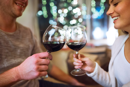 Couple at Christmas time, drinking wine.の写真素材