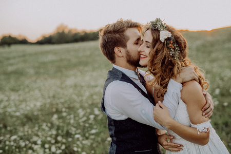 Beautiful bride and groom at sunset in green nature.の写真素材