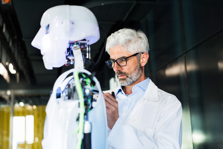 Businessman or a scientist with a robot.の写真素材