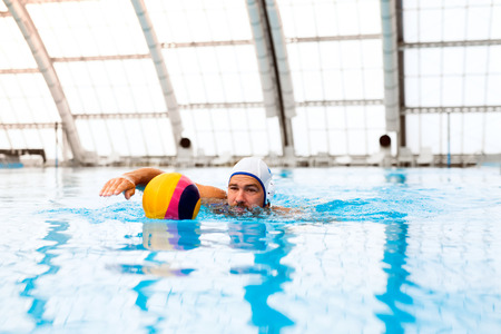 Water polo player in a swimming pool.の写真素材