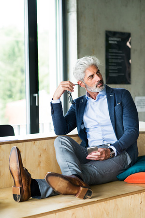 Thoughtful mature businessman in the office.の写真素材