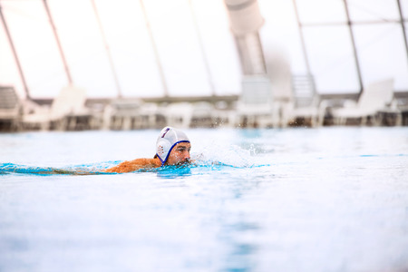 Water polo player in a swimming pool.の写真素材