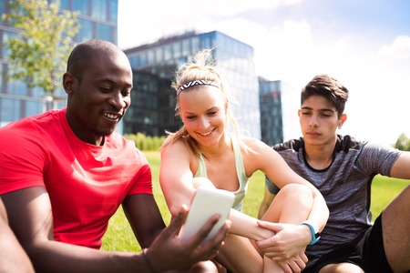 Young runners in the city with smart phone.の写真素材