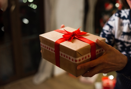Unrecognizable woman holding a gift at Christmas time.の写真素材