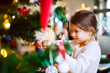 Small girl decorating Christmas tree.の写真素材