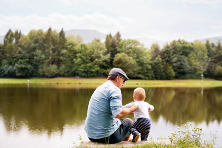 Father and the son by the lake in summer.の写真素材