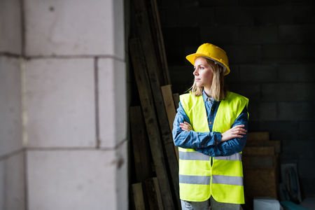 Young woman worker on the construction site.の写真素材