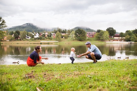 Little boy with parents making first steps.の写真素材