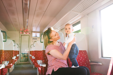 Young mother travelling with baby by train.の写真素材