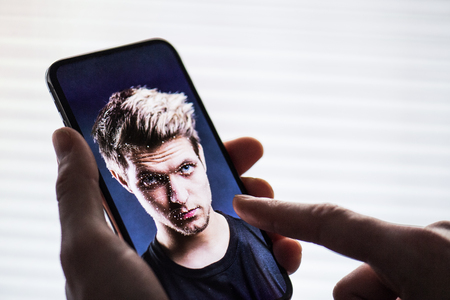 A smartphone using face ID recognition system.の写真素材