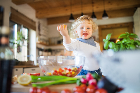 Toddler boy in the kitchen.の写真素材