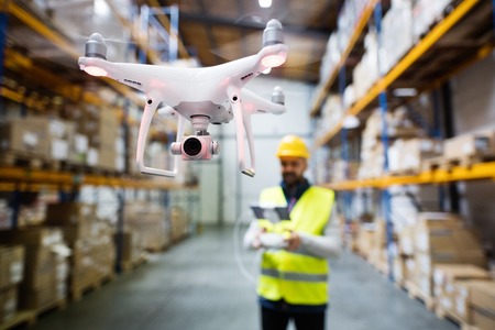 Man with drone in a warehouse.の写真素材