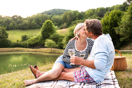 Senior couple at the lake having a picnicの写真素材
