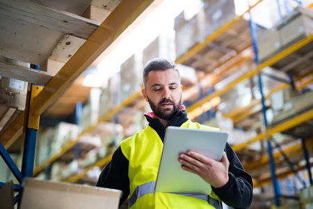 Male warehouse worker with tablet.の写真素材