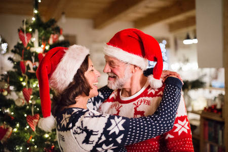 Senior couple with Santa hats at Christmas time.の写真素材
