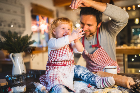 Young family making cookies at home.の写真素材