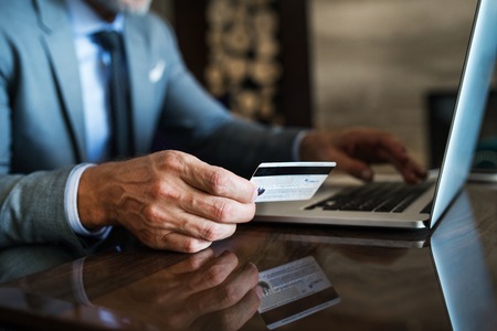 Businessman with laptop in a hotel lounge.の写真素材