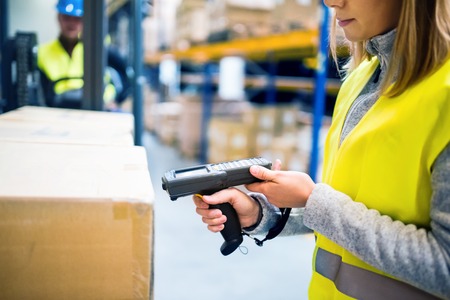 Warehouse woman worker with barcode scanner.の写真素材