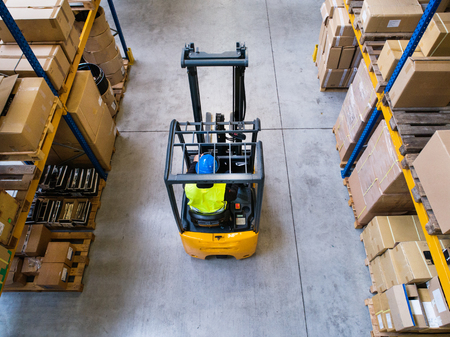 Warehouse man worker with forklift.の写真素材