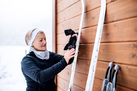 Senior woman getting ready for skiing.の写真素材