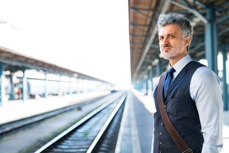 Mature businessman on a train station.の写真素材