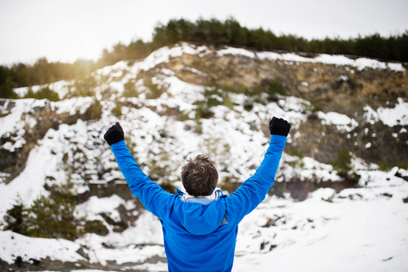 Senior man jogging in winter nature.の写真素材