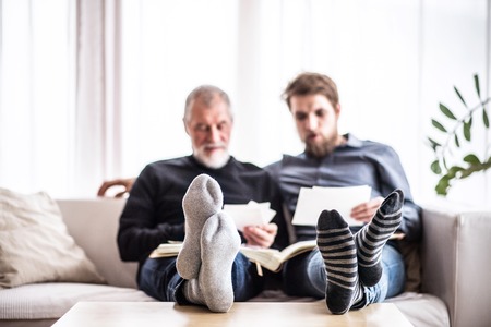 Hipster son and his senior father at home.の写真素材