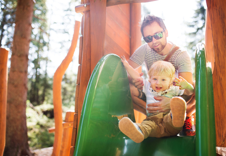 Father with little boy on the playground.の写真素材