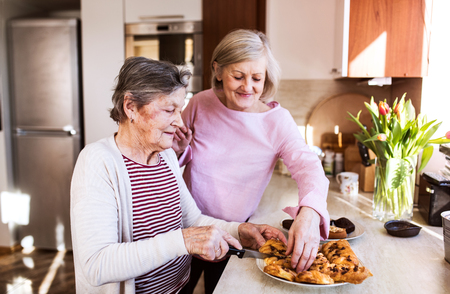 Senior women preparing food in the kitchen.の写真素材