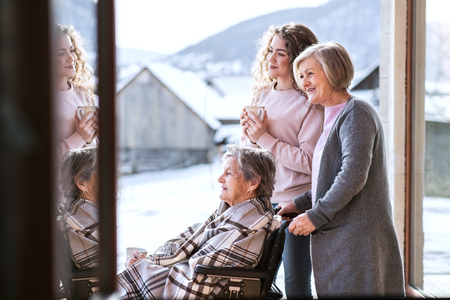 A teenage girl with mother and grandmother at home.の写真素材