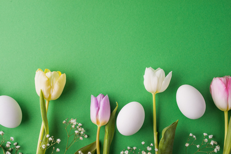 Easter and spring flat lay on a green background.