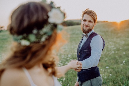 Beautiful bride and groom at sunset in green nature.の写真素材