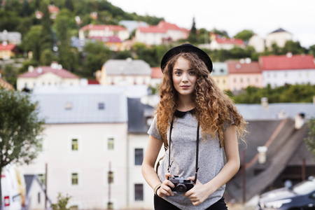Beautiful young tourist with camera in the old town.の写真素材