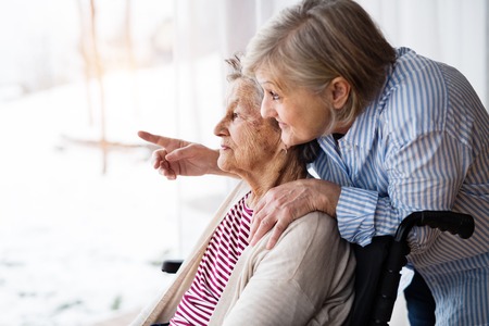 Senior women with wheelchair at home.の写真素材