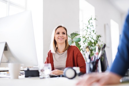 Businesswoman at the desk in her office.の写真素材