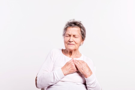 Studio portrait of a senior woman in pain. Close up.の写真素材