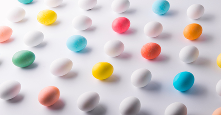 Eggs flat lay on a white background. Easter and spring composition.の写真素材