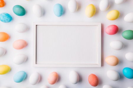 Eggs flat lay on a white background. Easter and spring composition.の写真素材