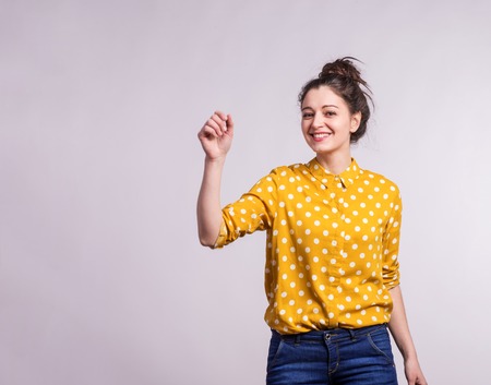 Portrait of a young beautiful woman in studio.の写真素材