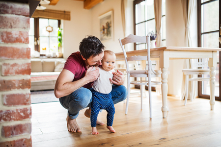 Father with a baby girl at home.の写真素材